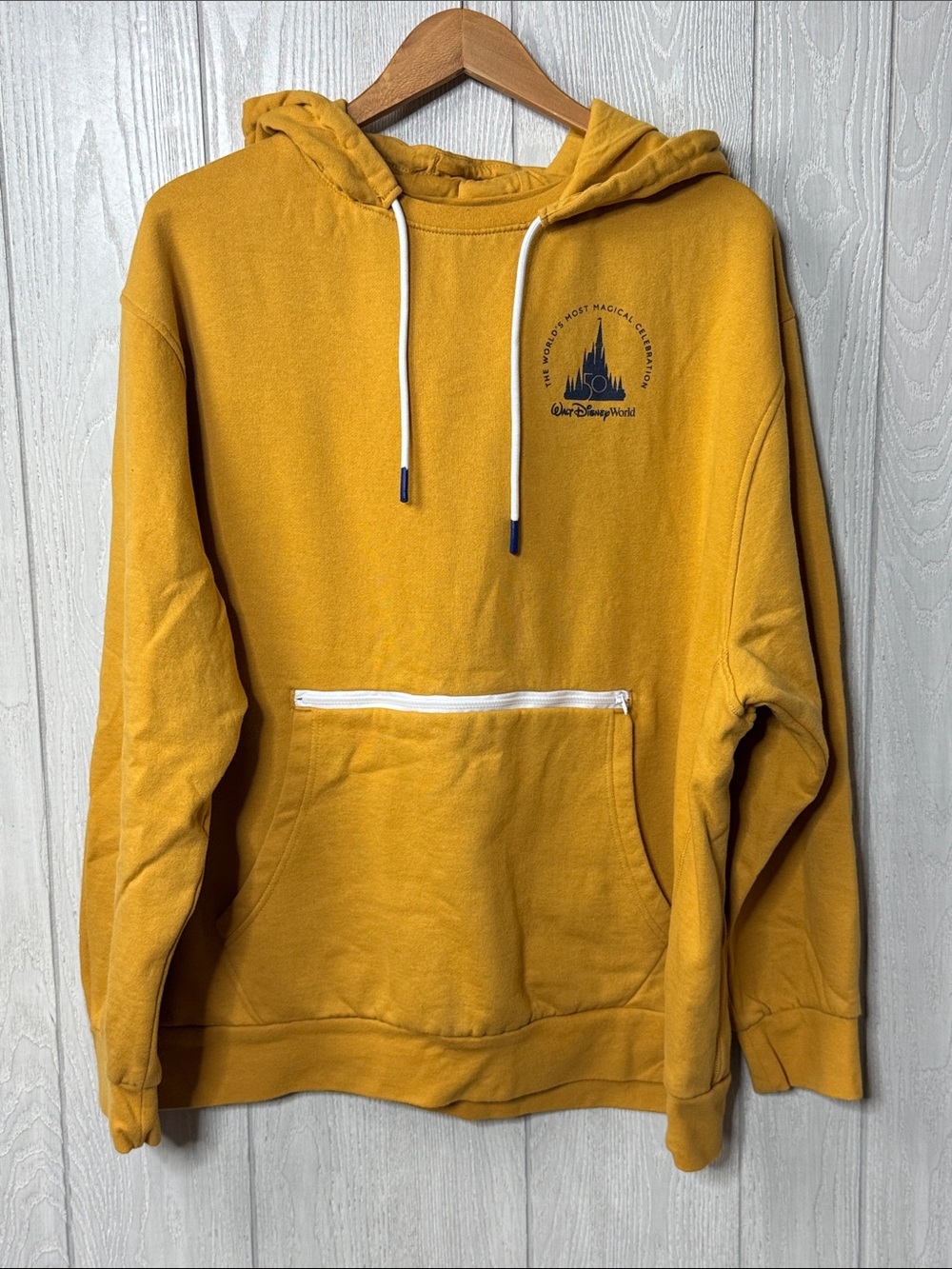 Gold Walt Disney World 50th Anniversary pullover hoodie featuring a small circul